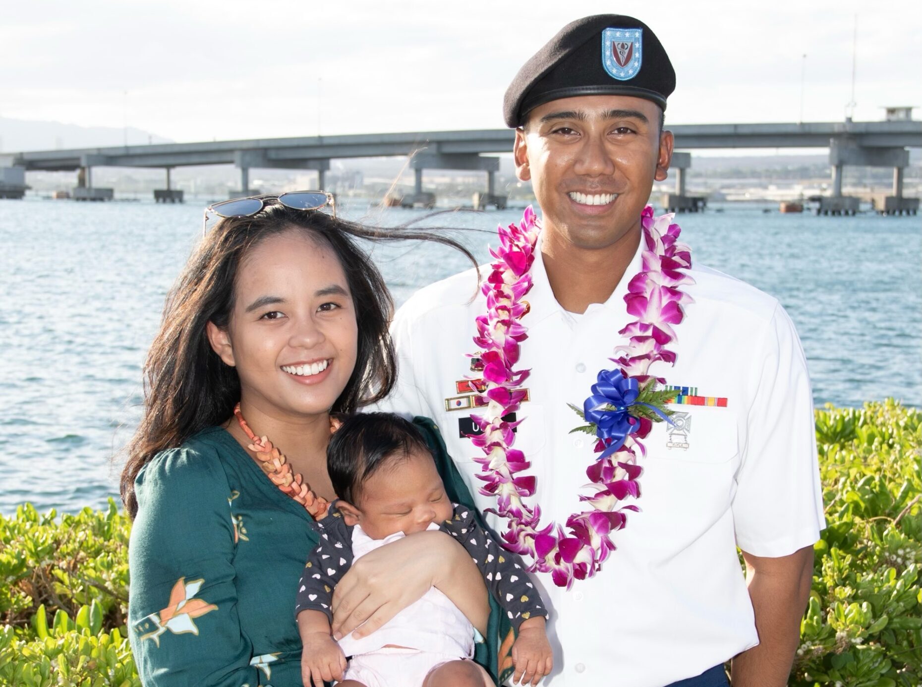 man and woman holding baby