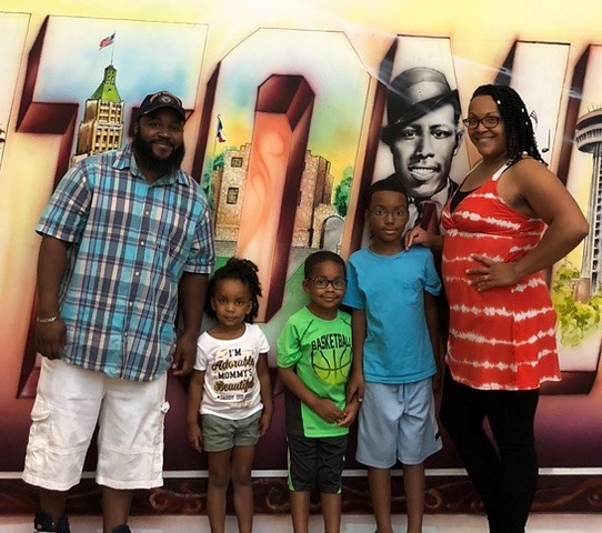 family standing together smiling