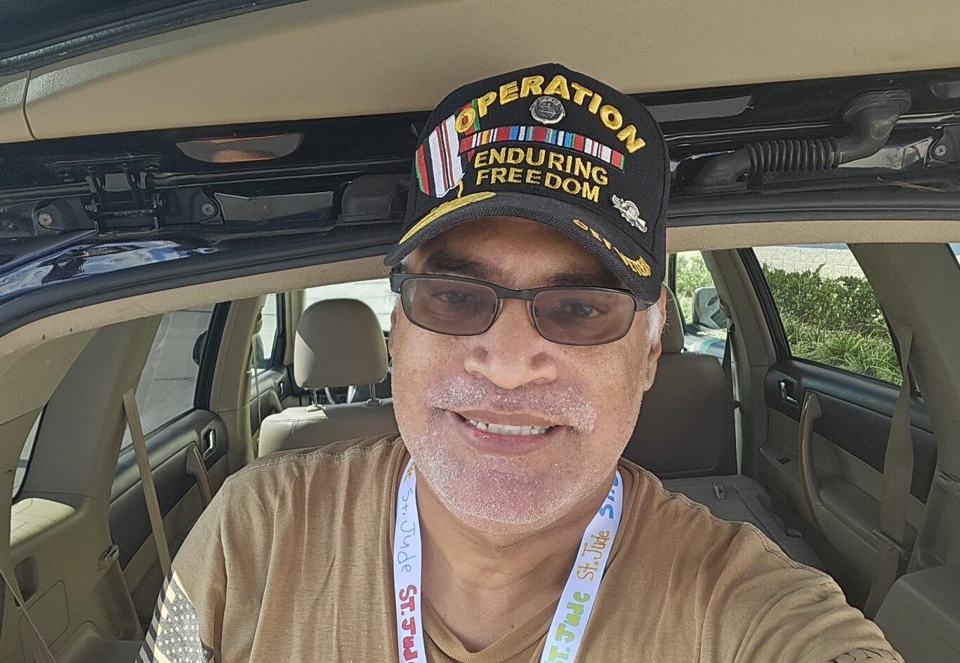 man sitting in his car and smiling