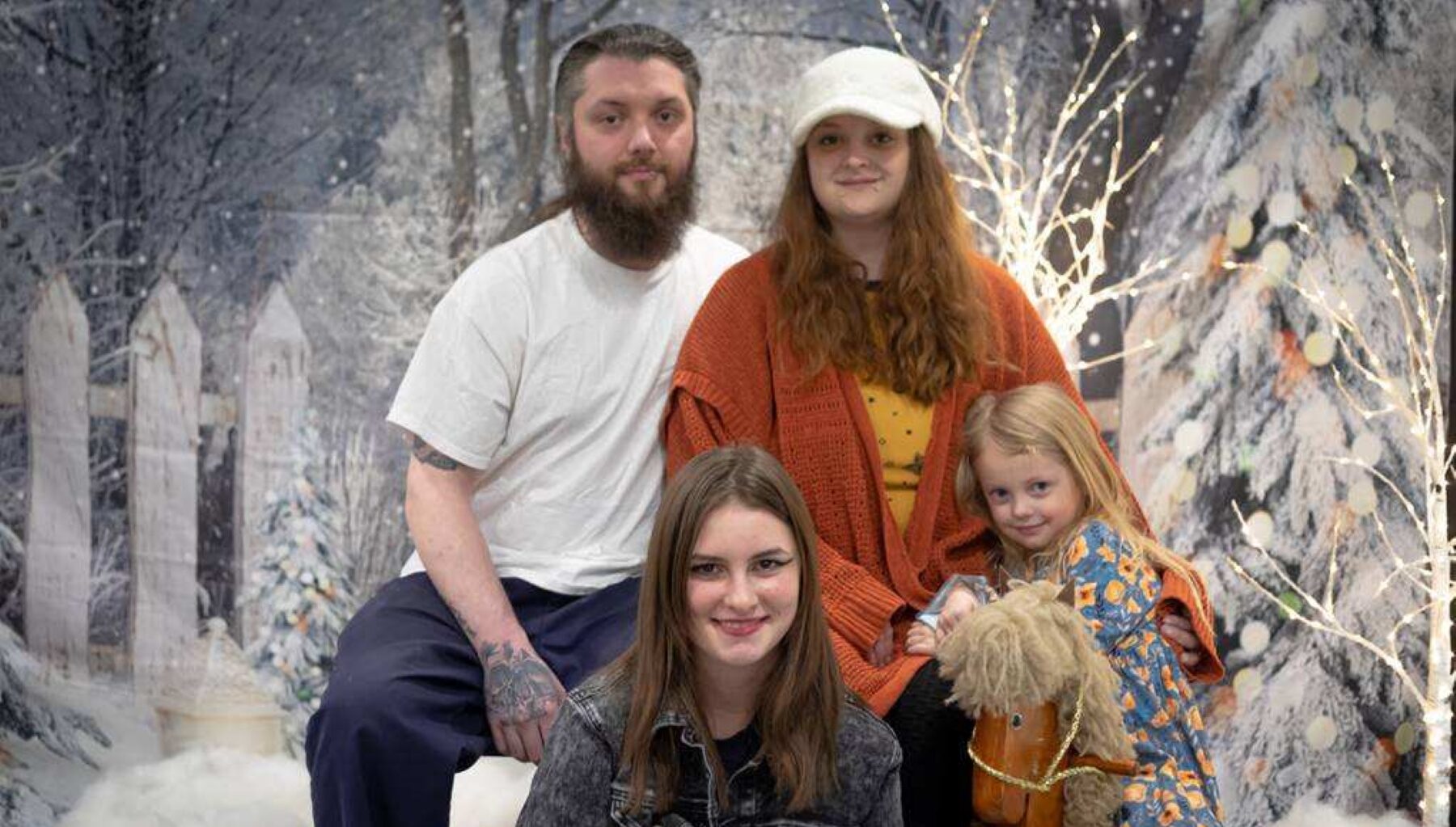 holiday photo of father, mother, and two daughters