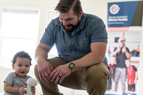 A photo of a parent and a child holding a stuffed animal.