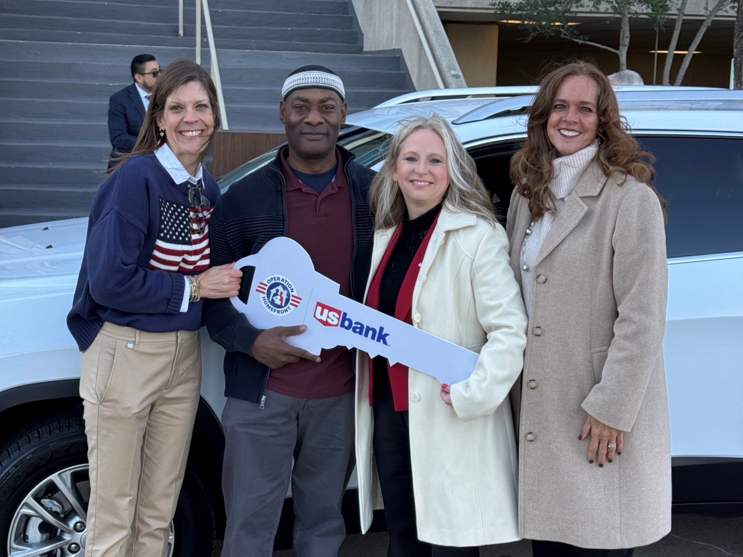 family in front of new car with key