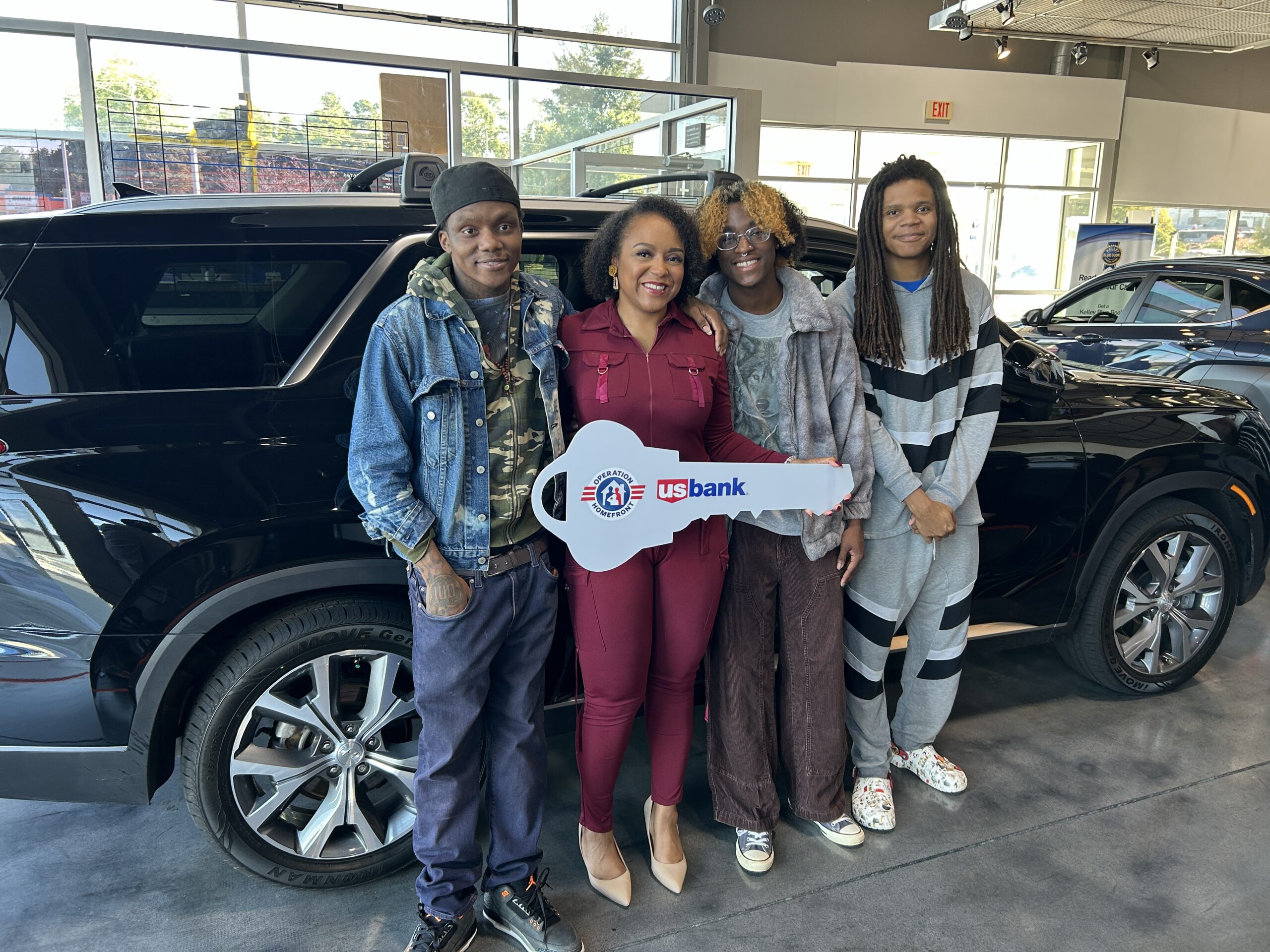 family in front of new car