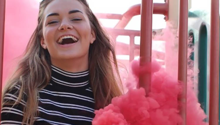 girl laughing while outside.