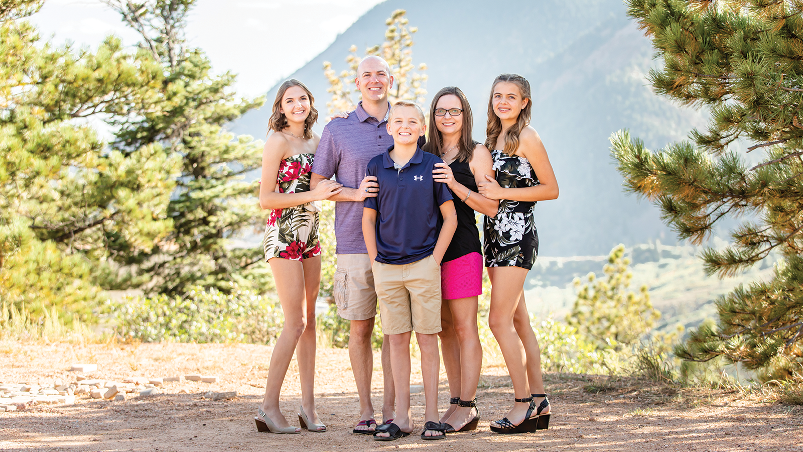 Family standing in a park.