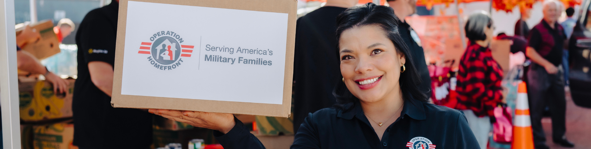 woman smiling holding box